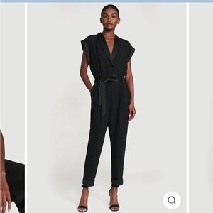 Sleek tuxedo jumpsuit with a tie waist, cap sleeves, cuffed hems & deep vneck